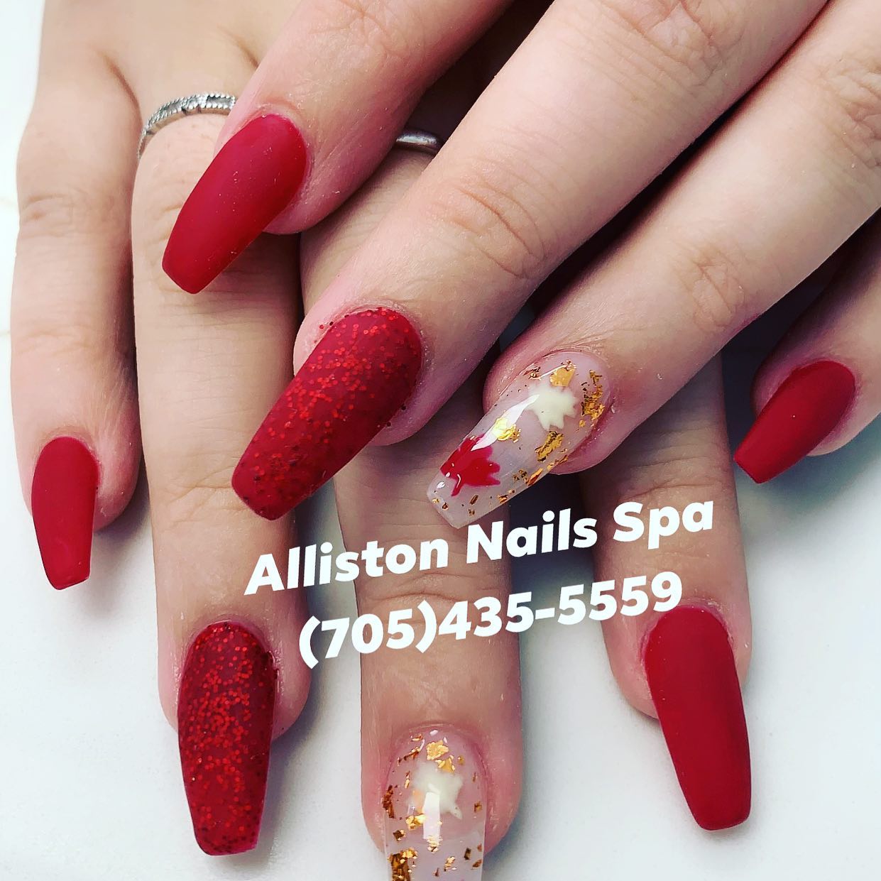 Red matte nails with glitter and maple leaf art